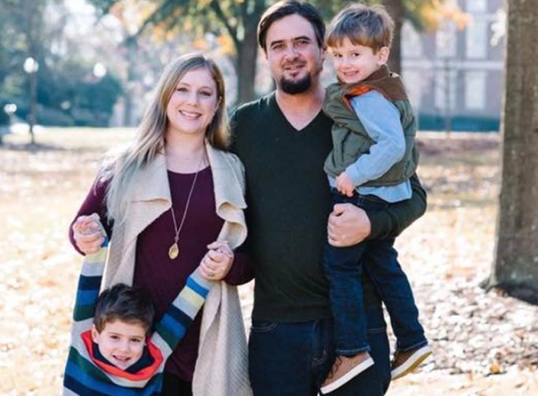 family with two children on a park